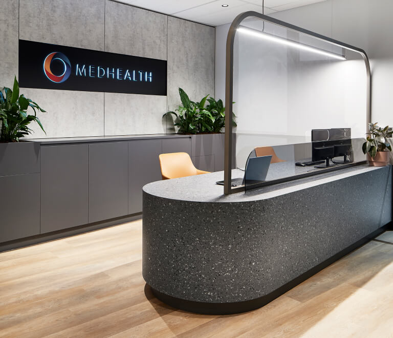Modern office reception area with Medhealth corporate logo on the wall, designed by MOO Marketing Design marketing agency in Melbourne