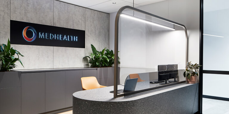 Medhealth reception area with wall-mounted logo